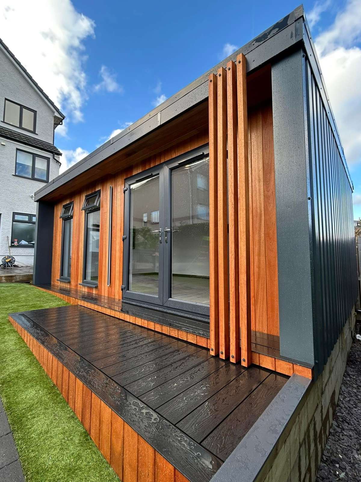 Timber clad cabin with composite decking, in daylight