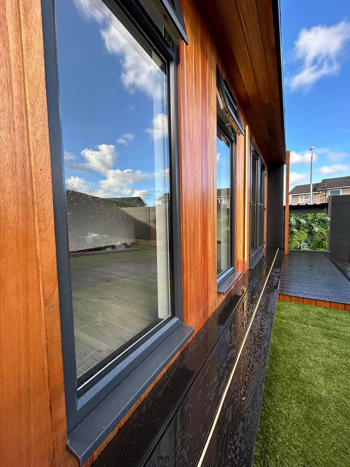 Close view of vertical timber cladding beside a window