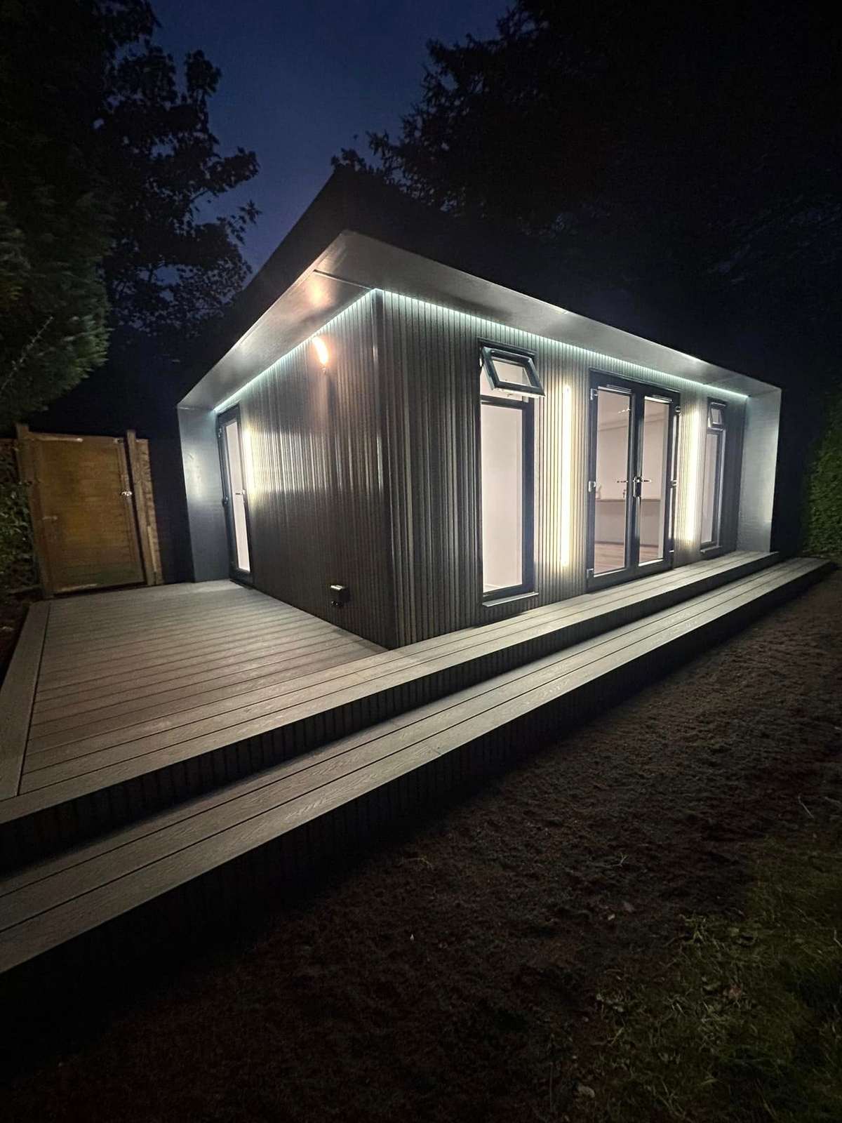 Dark clad cabin and decking at dusk