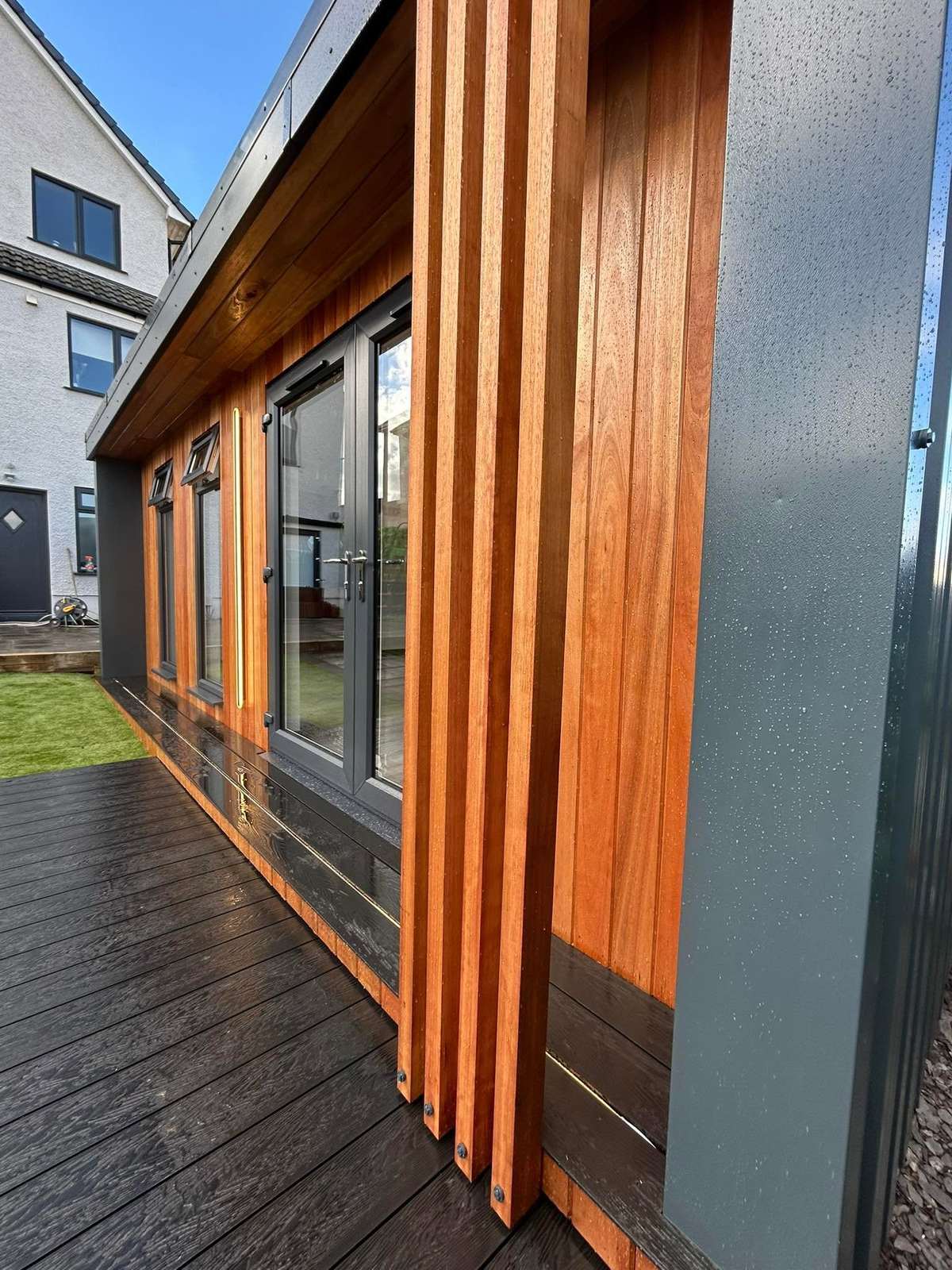 Corner of a timber clad cabin in daylight