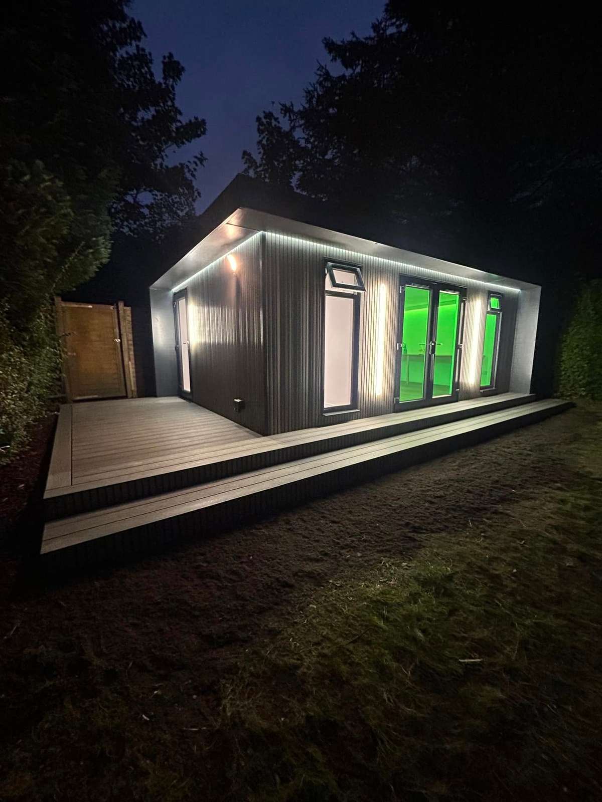 Garden room with green LED light, at night